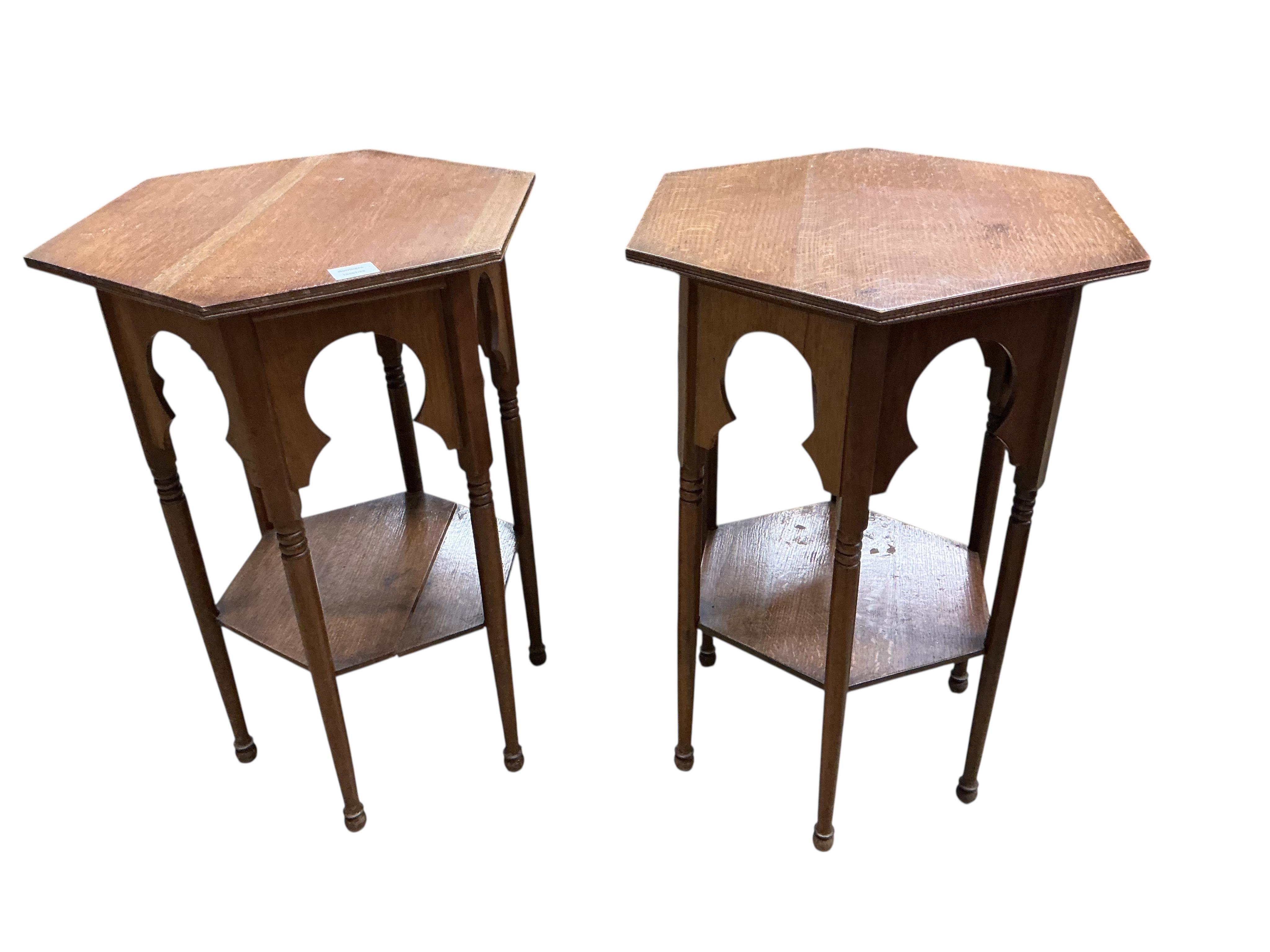 A pair of early 20th century Liberty style hexagonal oak two tier occasional tables, width 48cm, height 71cm